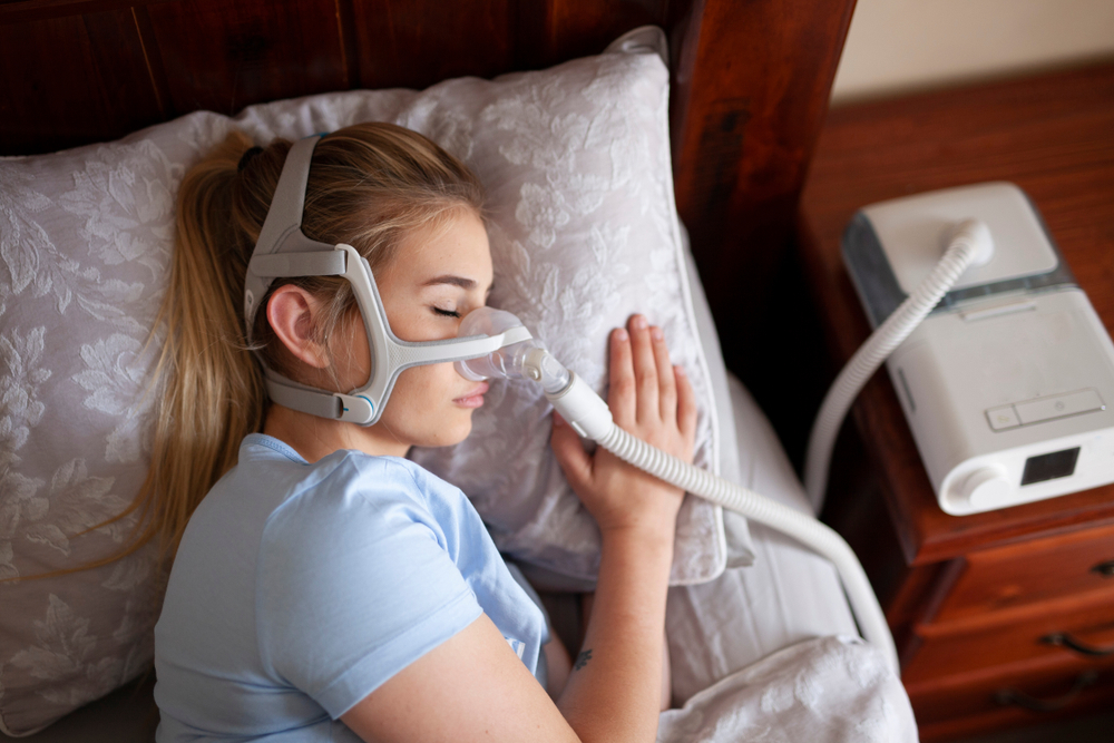 Patient using a home sleep apnea test device in Wichita, Kansas to detect sleep apnea