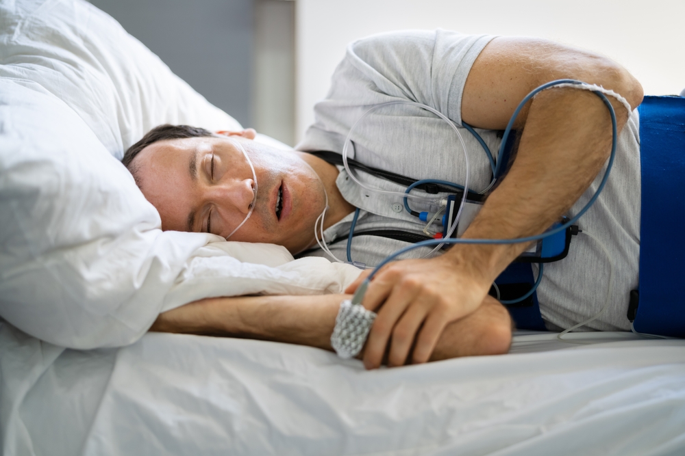 Patient using a home sleep apnea test (HSAT) device in Wichita, Kansas to detect sleep apnea